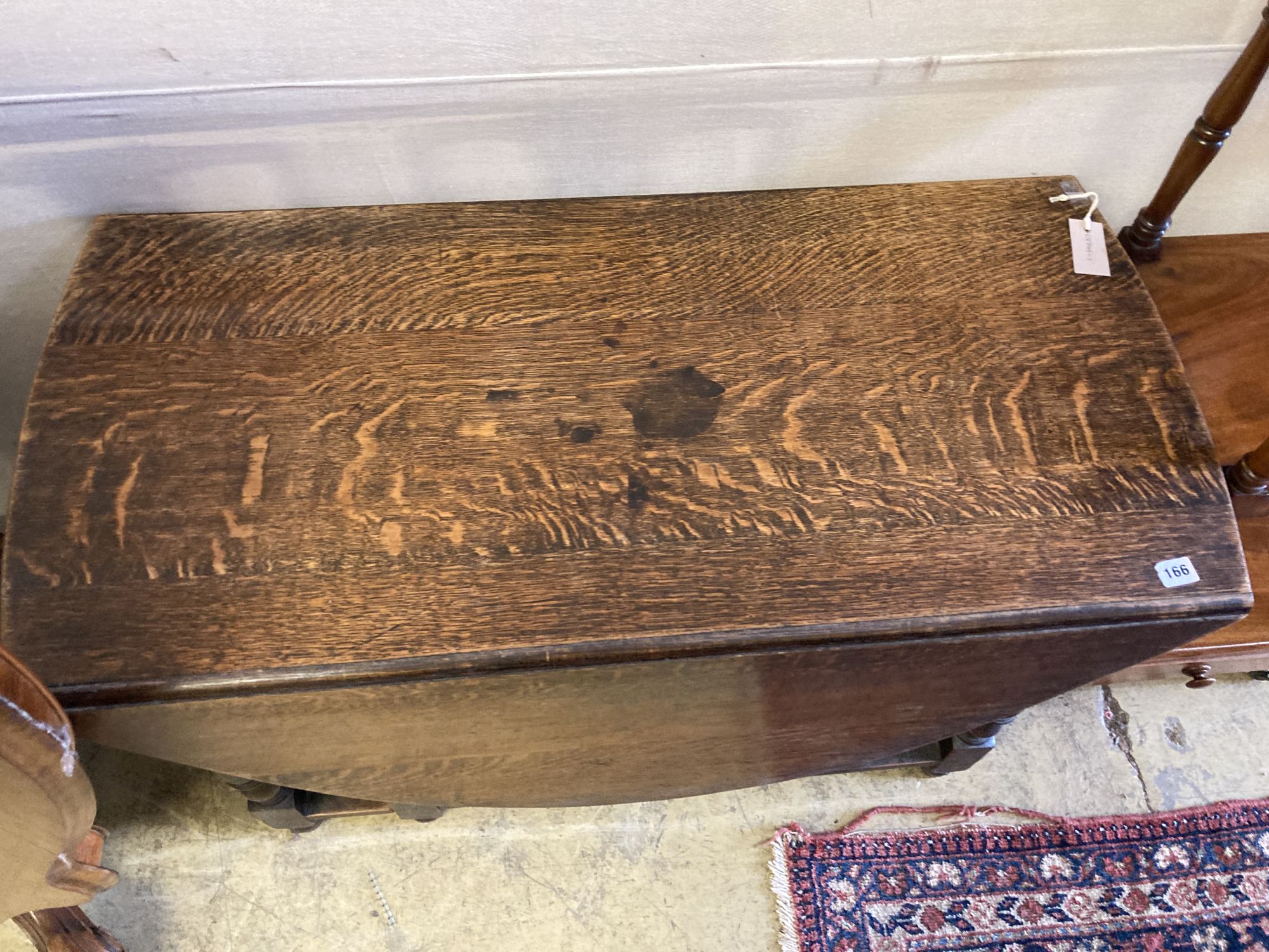 An oak gateleg dining table, length 106cm, depth 50cm, height 73cm